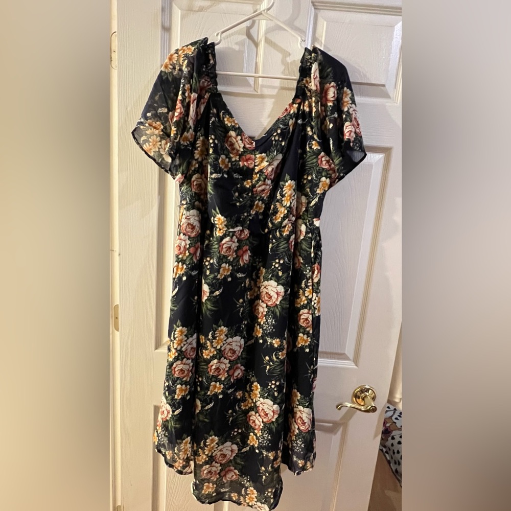 BloomChic navy dress with large floral print and raglan set sleeves.